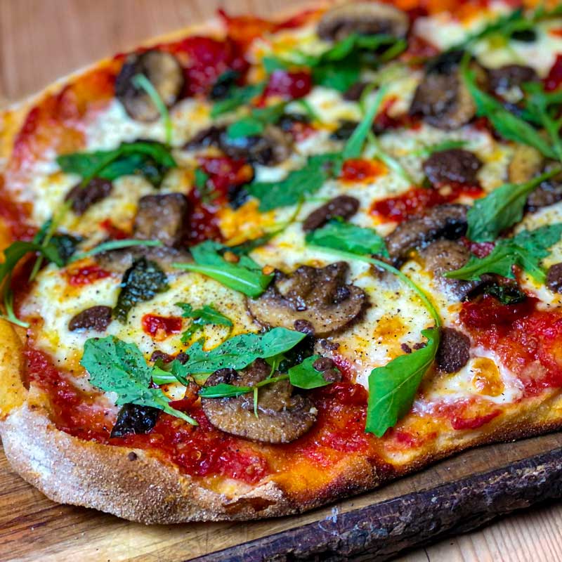 Pinsa Romana with Pepperoncini, fior di latte, mushrooms and rocket recipe for pizza