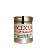 Korean Gochugaru Coarse Red Pepper Powder in a silver canister i with on a white background