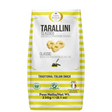 A 230g bag of Terre di Puglia Tarallini Classico with extra virgin olive oil, featuring a white bag with yellow stripes and a picture of three golden tarallini.