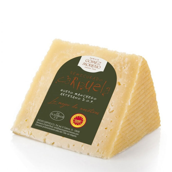 A 250g piece of DOP semi-cured manchego cheese from the Familia Gomez Moreno producer on a white background