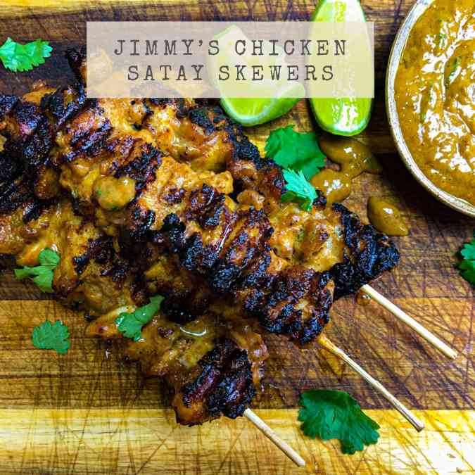 A picture of the recipe for Jimmy's Chicken Satay Skewers showing three delicious satay skewers with peanut dipping sauce and lime wedges