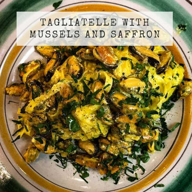 Tagliatelle pasta with mussels and saffron on a plate with text overlay